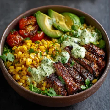 A bowl of food with steak, avocado, and roasted corn.