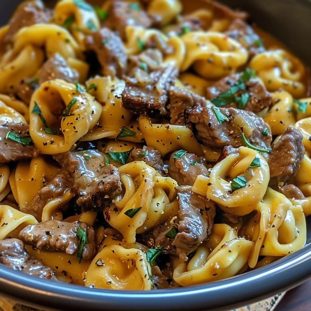A bowl of pasta with meat and cheese.