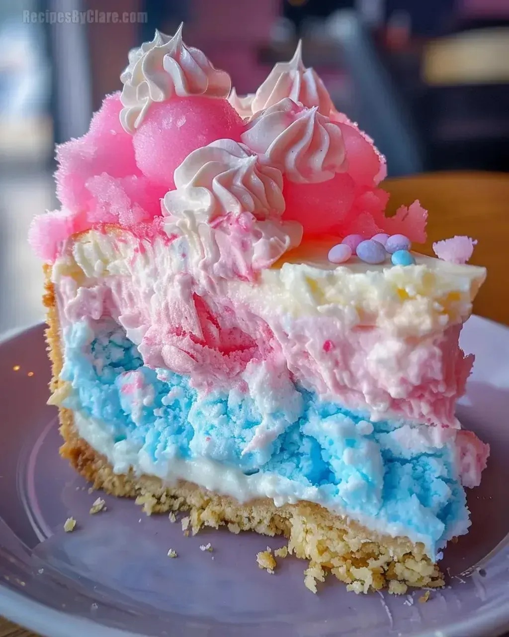 A slice of cotton candy cheesecake dessert.