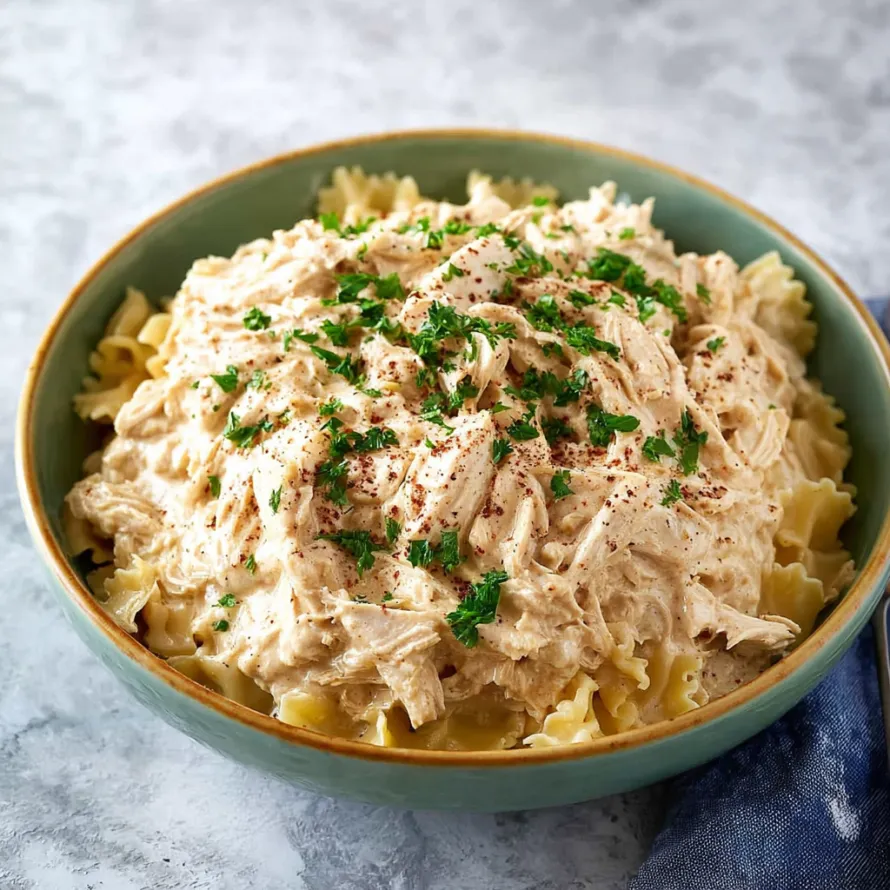 A bowl of chicken and pasta.