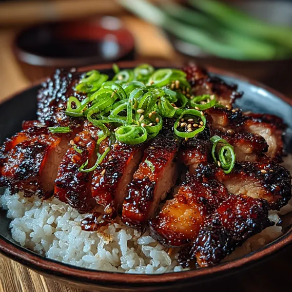 A plate of Char Siu Chicken with rice and green onions.