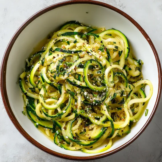 A bowl of garlic-infused zoodles with olive oil.
