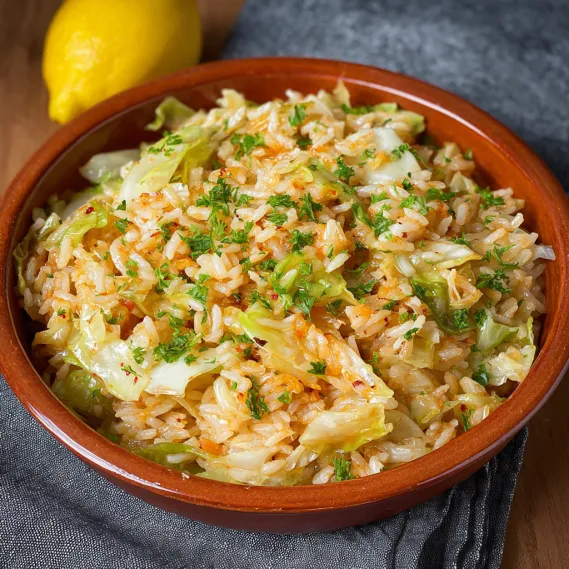 A bowl of rice with cabbage and other vegetables.