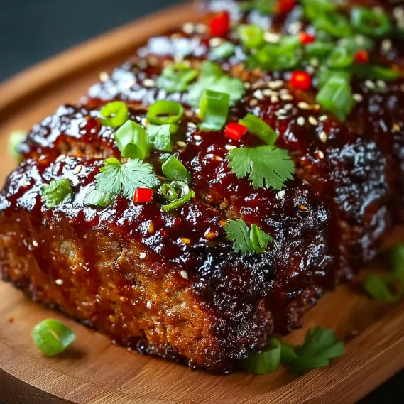 A piece of meat with a sauce on it.