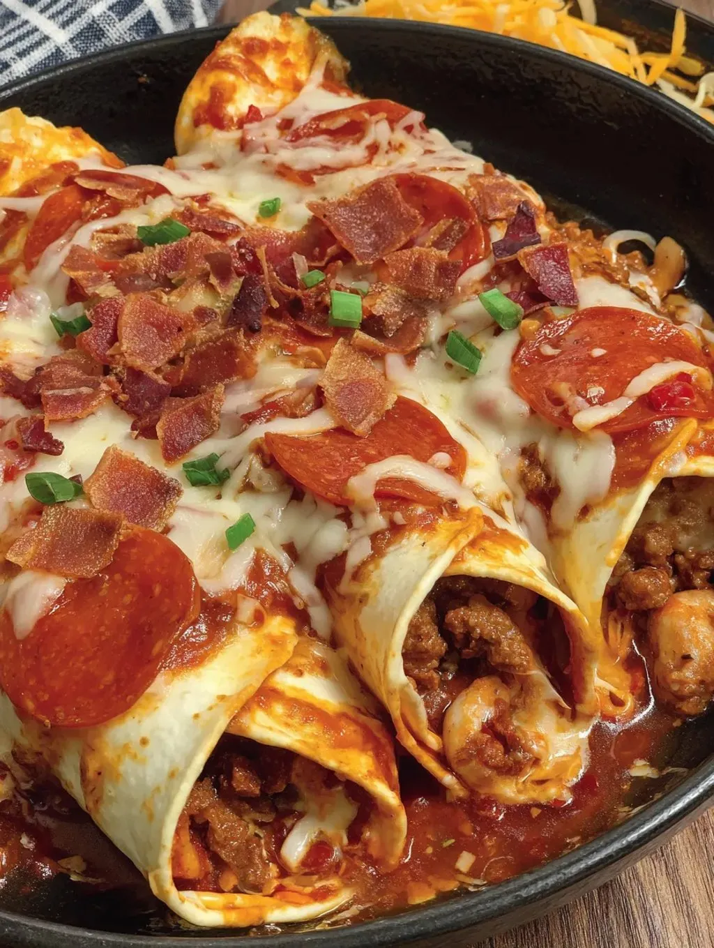 A plate of pizza enchiladas with ground beef.