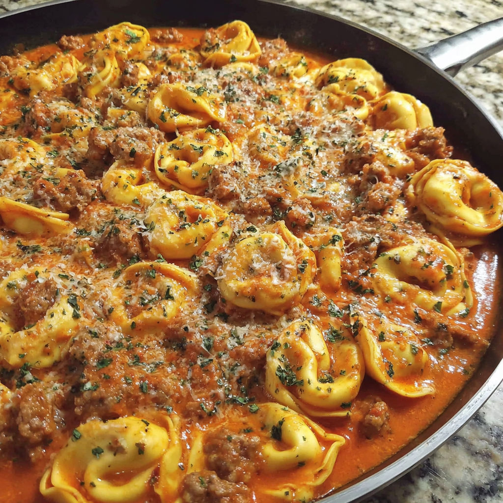 A pan of creamy Italian sausage tortellini.