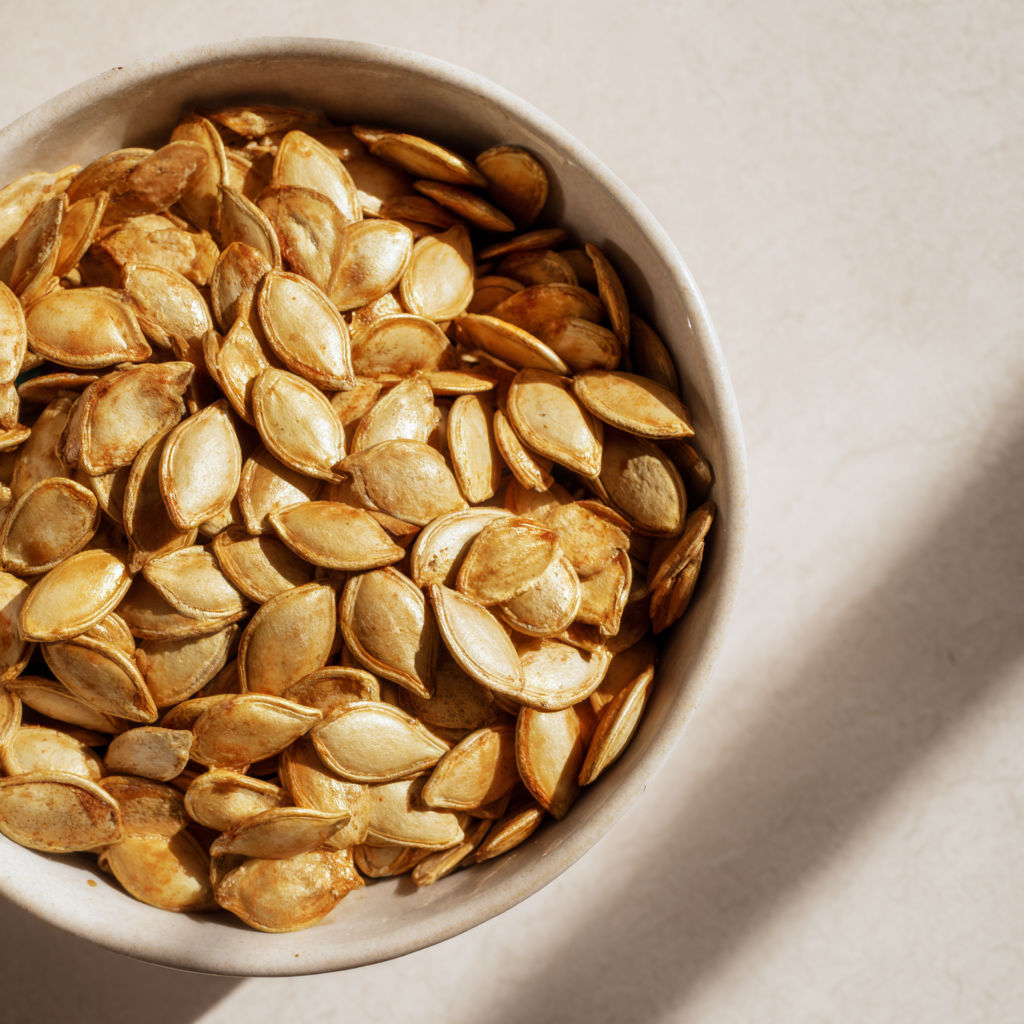A bowl of roasted pumpkin seeds.