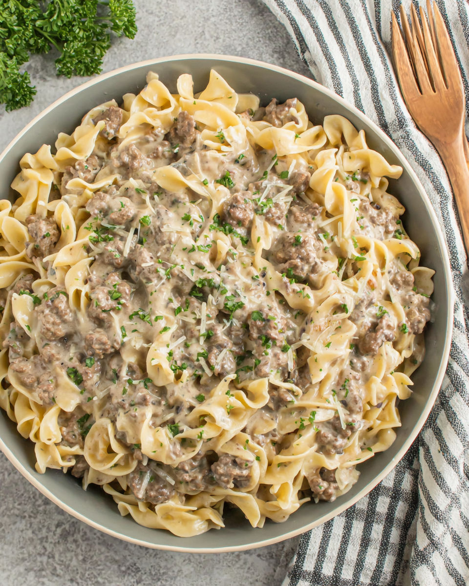 A bowl of pasta with meat and cheese.
