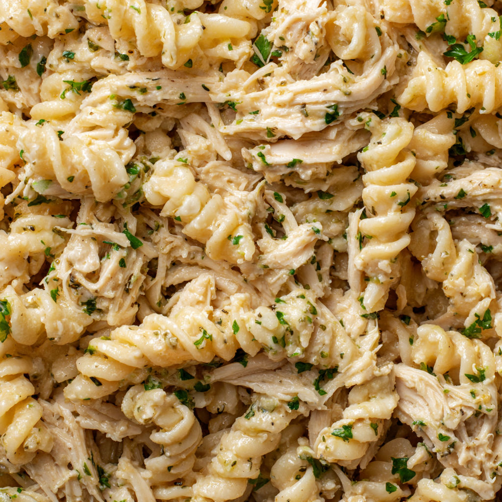 A close up of a crockpot garlic parmesan chicken pasta dish.