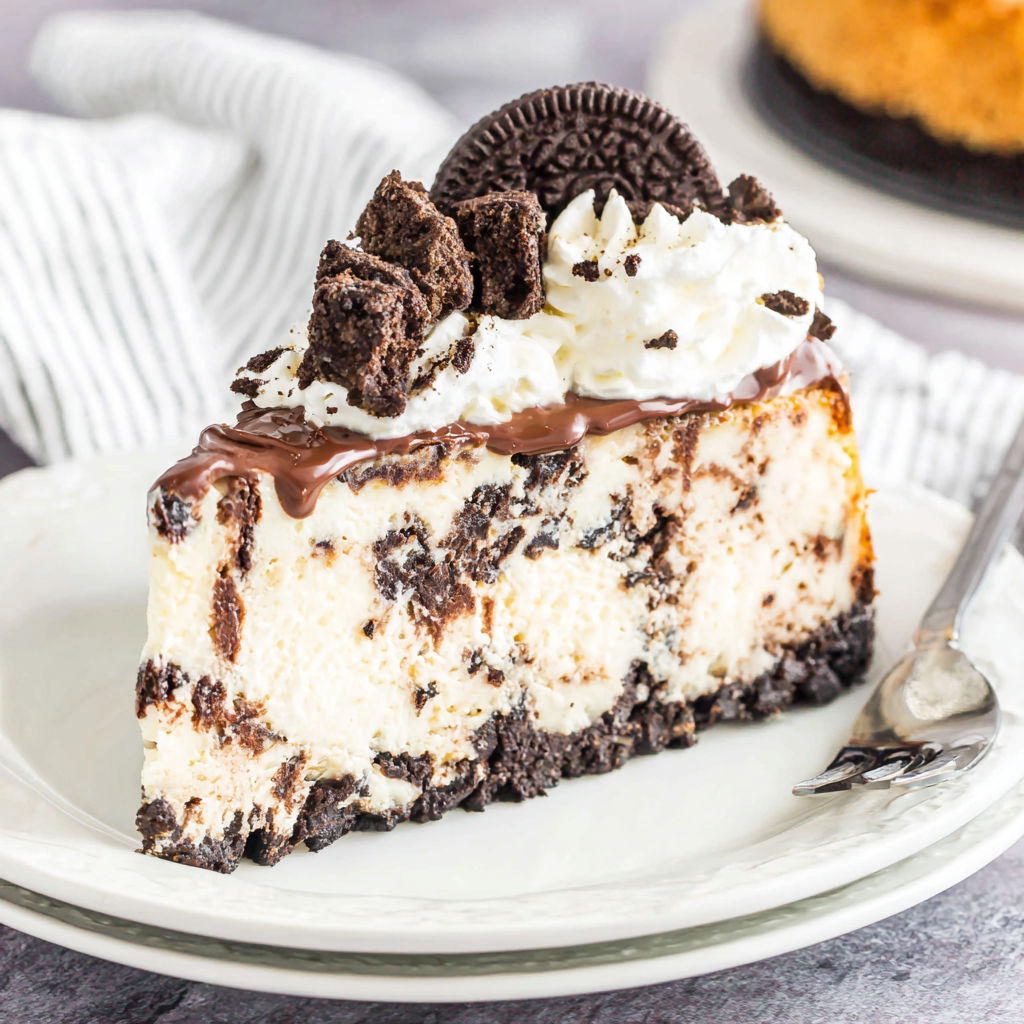 A slice of Oreo cheesecake with chocolate drizzle.