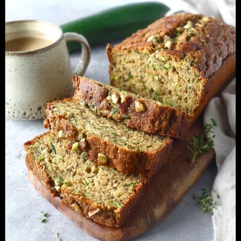 A loaf of bread with a green vegetable on top.
