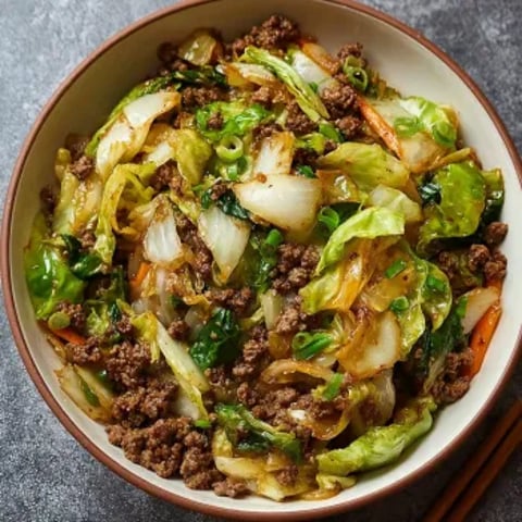 A bowl of Chinese ground beef and cabbage stir-fry.