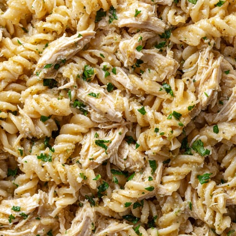 A close up of a crockpot garlic parmesan chicken pasta dish.