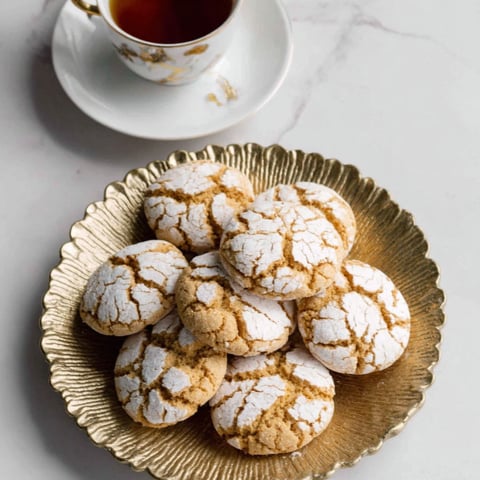 A plate of cookies with a cup of tea.