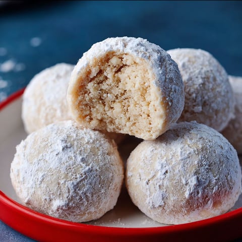 Snowball cookies on a plate.