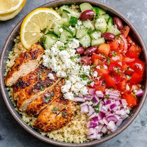 A bowl of Greek chicken with vegetables.
